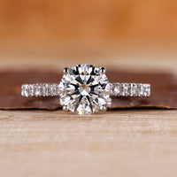 Round diamond engagement ring with pave setting ring.