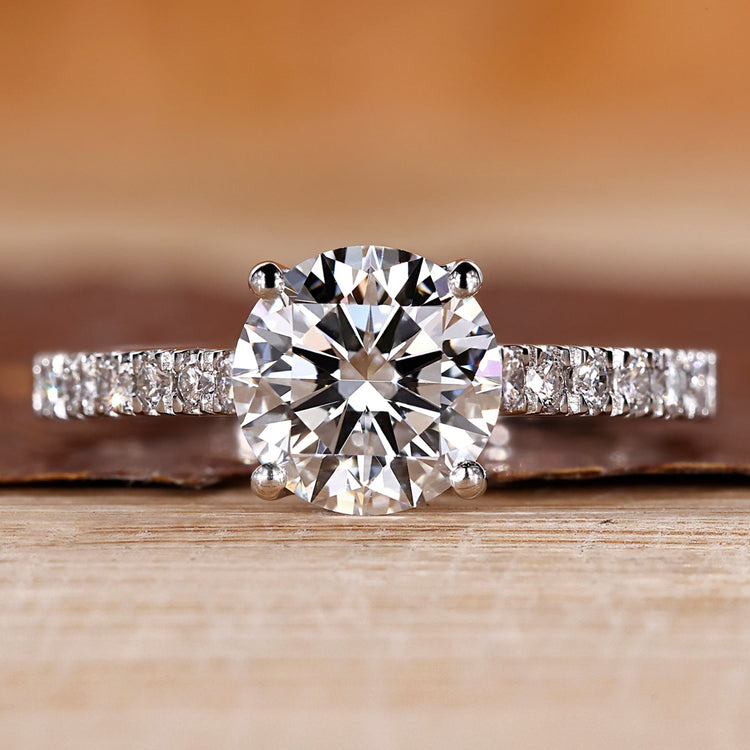 Round diamond engagement ring with pave setting ring.