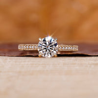 Yellow gold engagement ring with round diamond engagement ring.