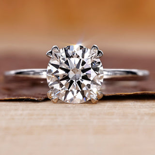 Solitaire engagement ring with round brilliant diamond in white gold.