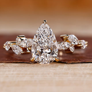 Pear diamond engagement ring with cluster engagement ring.