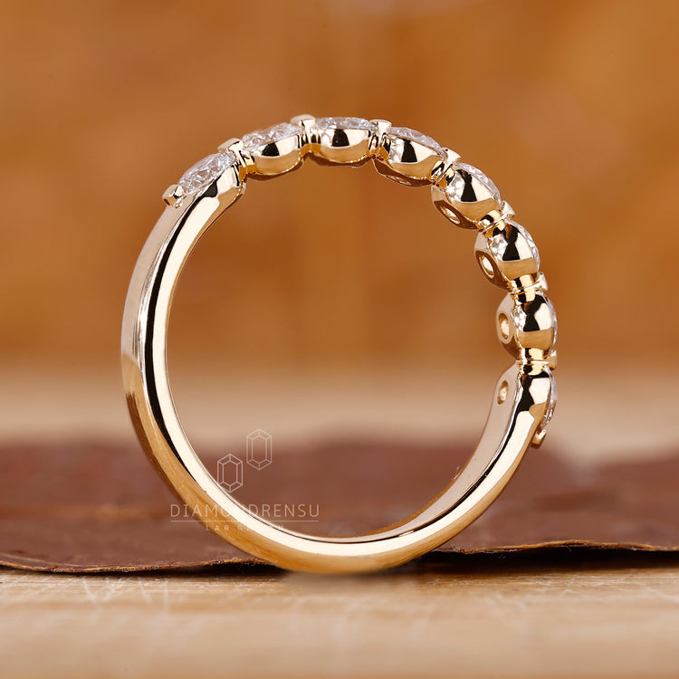 Yellow gold wedding band with lab diamonds.