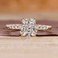 Cushion cut diamond ring with hidden halo ring.