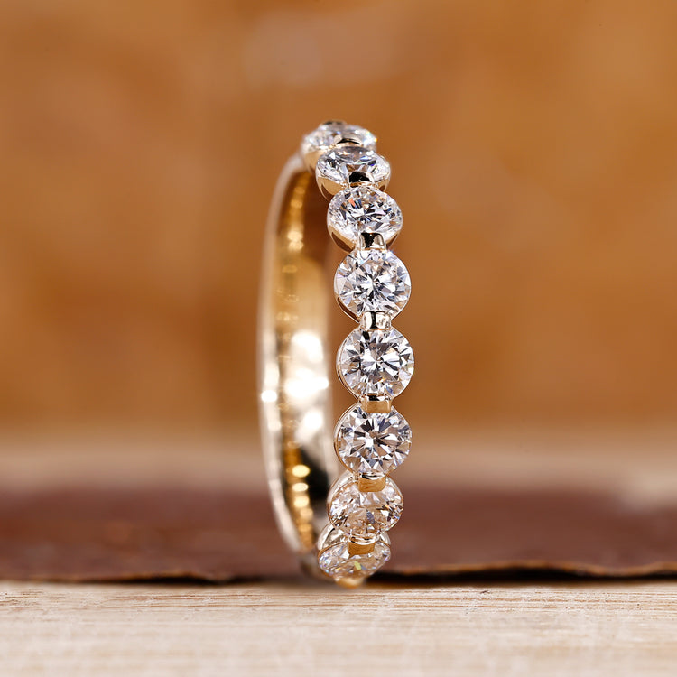 Round diamond wedding band in yellow gold.