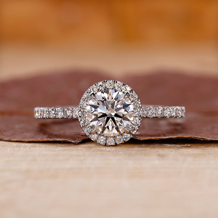 Pave diamond ring with round cut center stone.