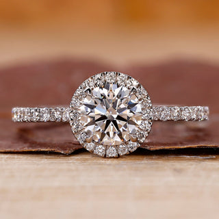 Pave diamond ring with round cut center stone.