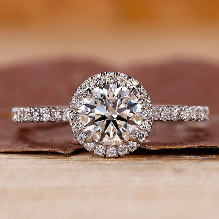 Pave diamond ring with round cut center stone.