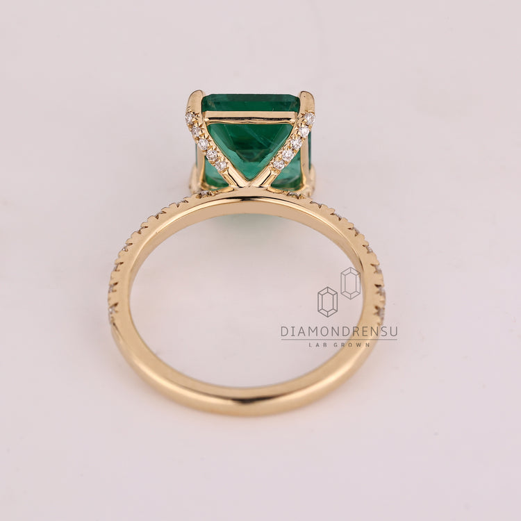 Asscher cut ring four claw prong pave style setting.