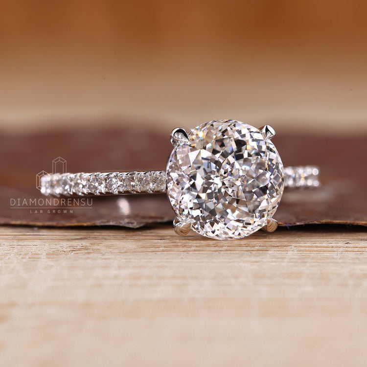 Pave Portuguese cut ring with round diamond setting.