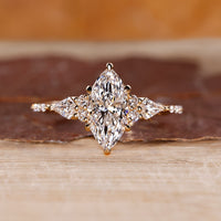 Marquise diamond engagement ring with kite and round side stones.