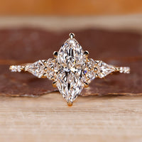Marquise diamond engagement ring with kite and round side stones.