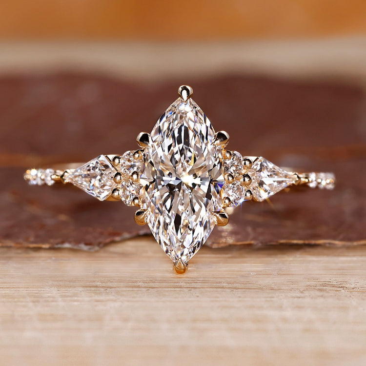 Marquise diamond engagement ring with kite and round side stones.