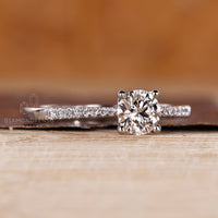 Pave round diamond ring tapered shank four prong set.