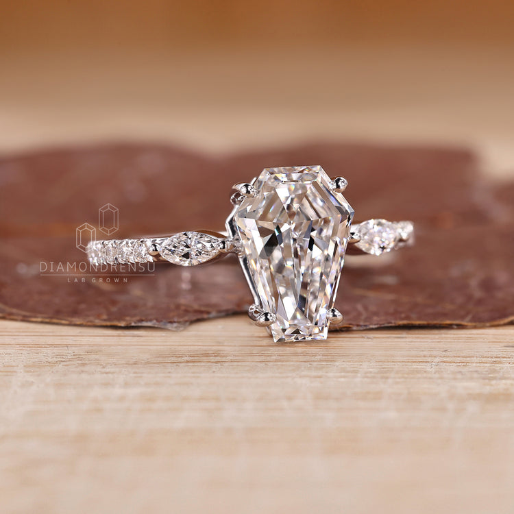 Coffin diamond ring marquise round side stones.
