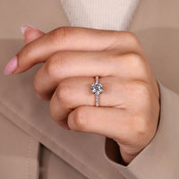 Round cut diamond ring with tulip basket details.
