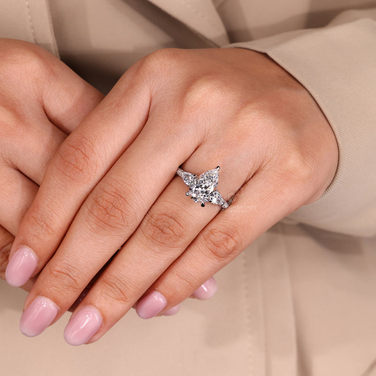 Pear cut diamond ring with three sided pave setting.