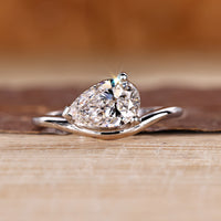 Pear diamond ring in solitaire style with east to west setting.