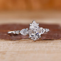 Seven stone pear diamond ring round side stones set.