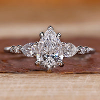 Pear cut diamond ring pear round side stones seven stone.