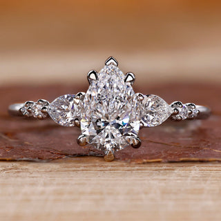 Pear cut diamond ring pear round side stones seven stone.