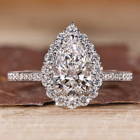 Pear cut diamond ring halo pave three claw prong set.