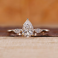 Pear cut diamond ring with marquise cut side stones.