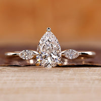 Pear cut diamond ring with marquise cut side stones.
