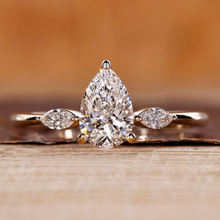 Pear cut diamond ring with marquise cut side stones.