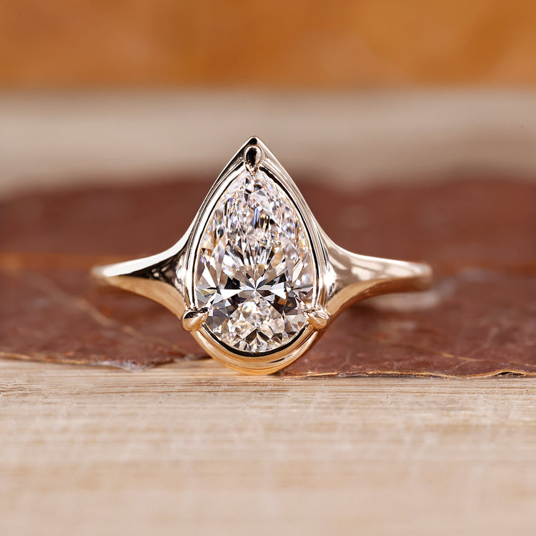 Pear cut diamond ring bezel prong solitaire style.