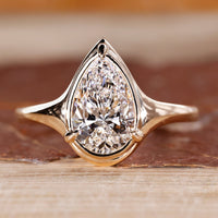 Pear cut diamond ring bezel prong solitaire style.