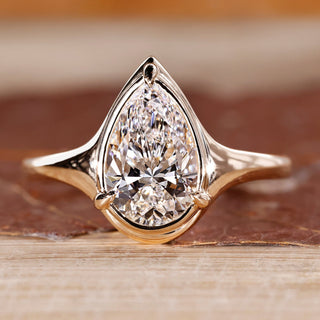 Pear cut diamond ring bezel prong solitaire style.