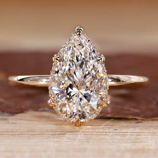 Hidden halo engagement ring with pear cut diamond centre.