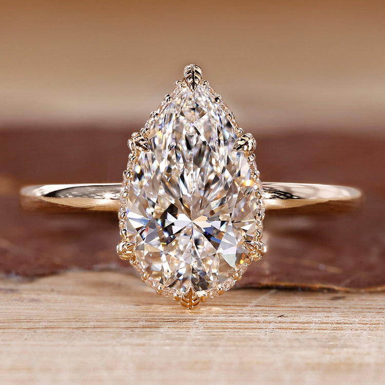Hidden halo engagement ring with pear cut diamond centre.