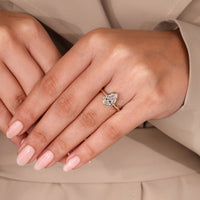 Pear cut diamond ring bezel type prong setting.