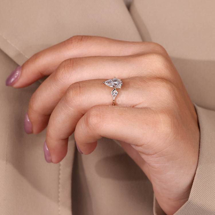 Pear cut diamond ring three claw prong tapered shank.