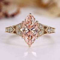 Marquise diamond ring with round side stones.
