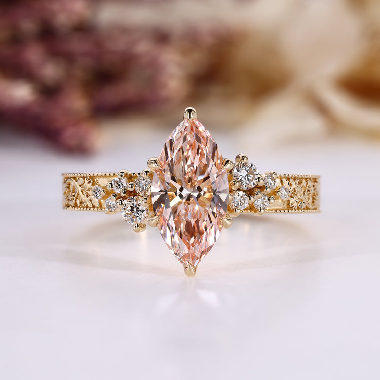 Pink diamond marquise ring with round side stones.