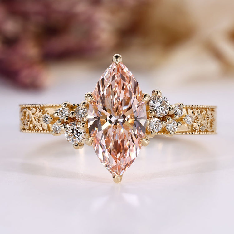 Pink diamond marquise ring with round side stones.