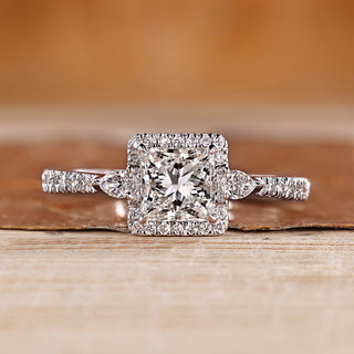 Princess cut diamond ring pear side stones.