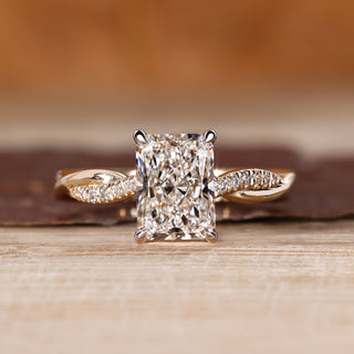 Radiant cut diamond ring with round diamond pave band.