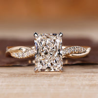 Radiant cut diamond ring with round diamond pave band.
