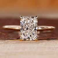 Radiant cut diamond engagement ring with round hidden halo.