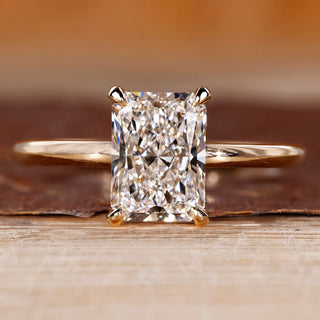 Radiant cut diamond engagement ring with round hidden halo.