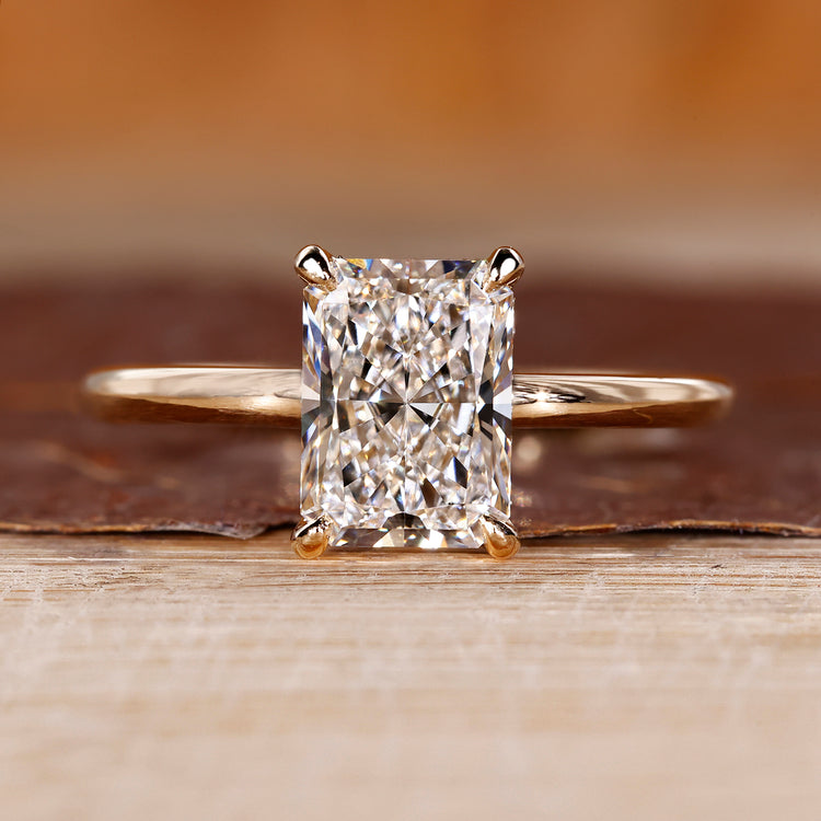 Radiant cut diamond engagement ring with round hidden halo.