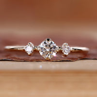 Round cut diamond ring minimalist three stone style.