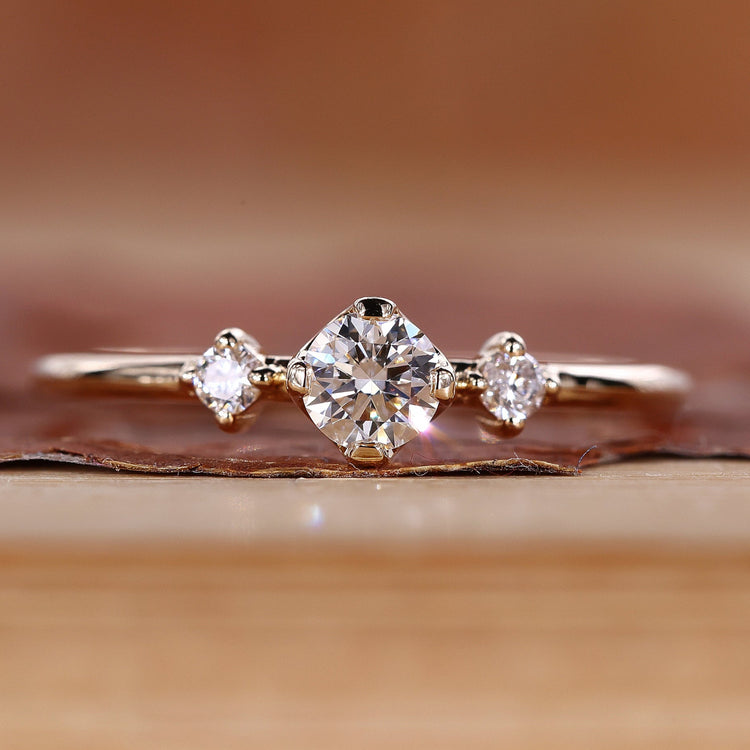 Round cut diamond ring minimalist three stone style.