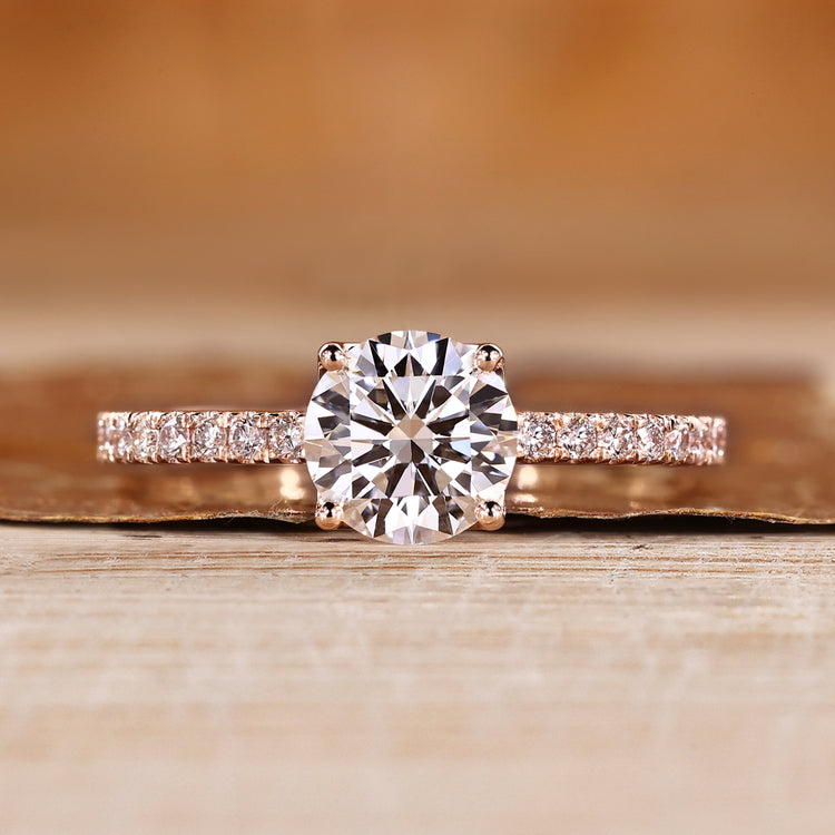 Round cut diamond ring with round diamond pave style.