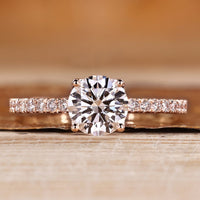 Round cut diamond ring with round diamond pave style.