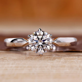 Round cut diamond ring solitaire pinched shank style.