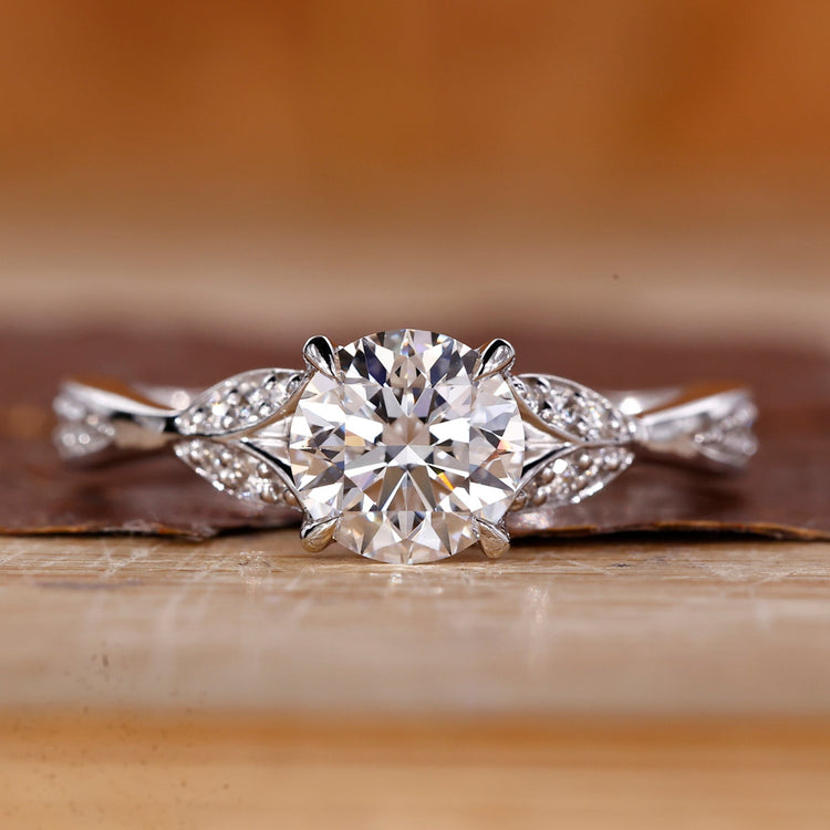 Round cut diamond ring wave split pave shank.